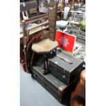 An early 20th century carved oak spinning stool with a hard seat, & on three turned legs; together