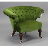 A 19th century tub-shaped easy chair upholstered buttoned green velour, on short turned front legs w