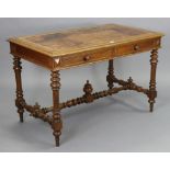 A continental oak writing table inset gilt-tooled tan leather to the rectangular top, fitted two
