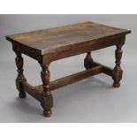 An oak refectory table in the 17th century style with a rectangular top, & on four baluster-turned