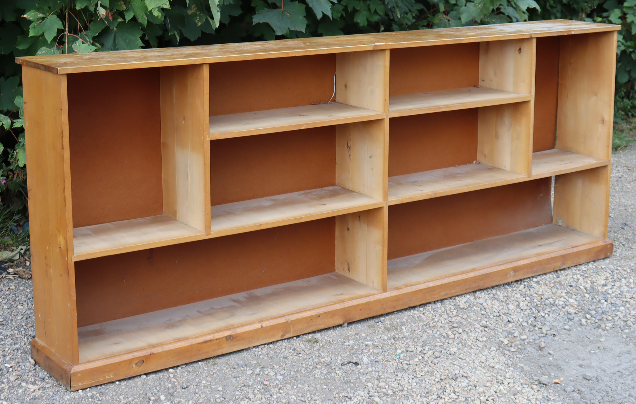 An elm dwarf standing long open bookcase with eight divisions, & on a plinth base, 97” long x 39”