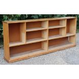An elm dwarf standing long open bookcase with eight divisions, & on a plinth base, 97” long x 39”