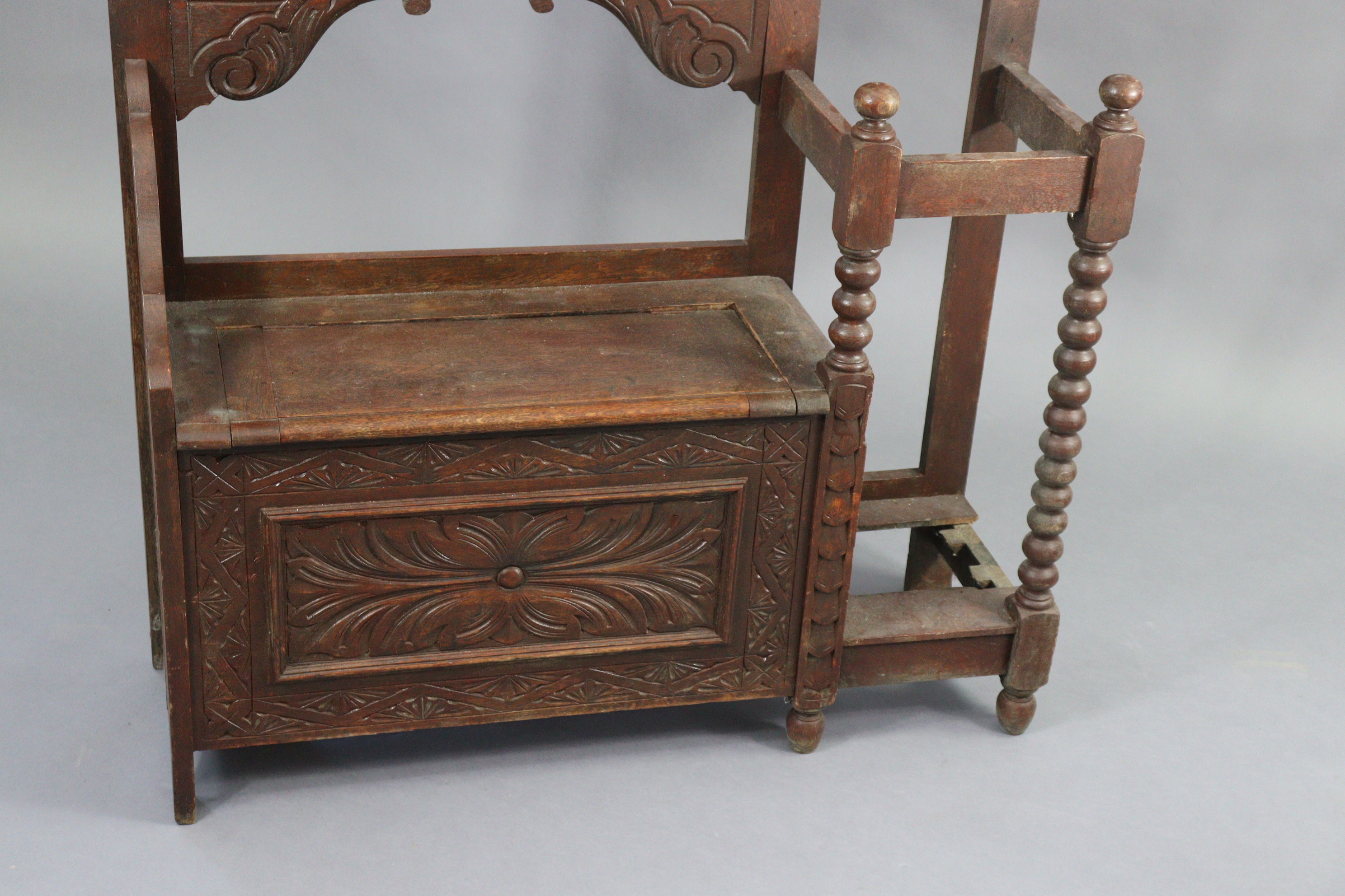 A 1930’s carved oak hall stand inset bevelled rectangular mirror to top, with a hinged box seat & - Image 2 of 7