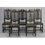 A set of five Carolean-style oak hall chairs, each with pierced & carved splat back, hard seat, & on