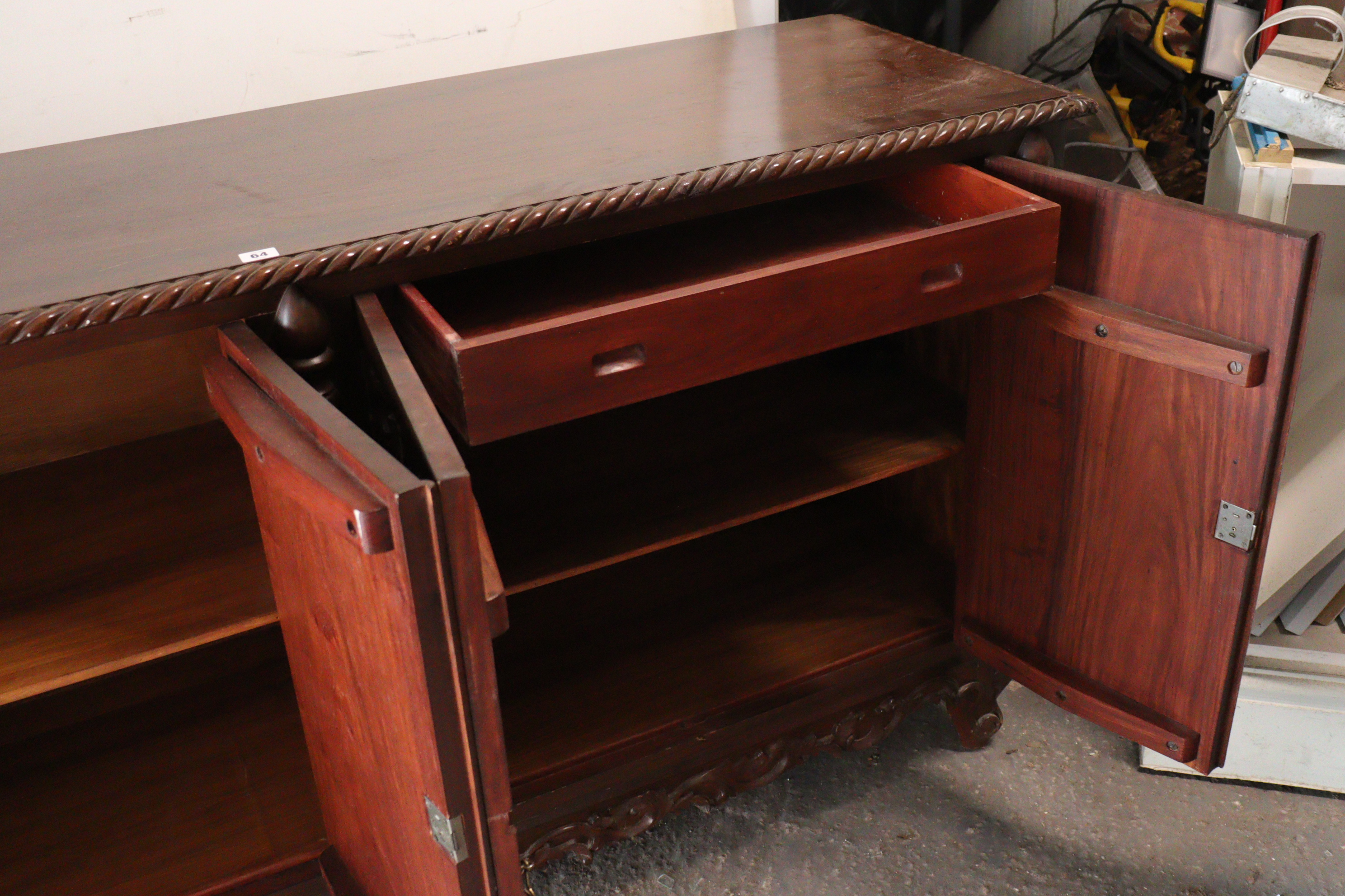 A mahogany sideboard with a gadrooned edge, enclosed by two pairs of carved panel doors, with a - Image 5 of 8
