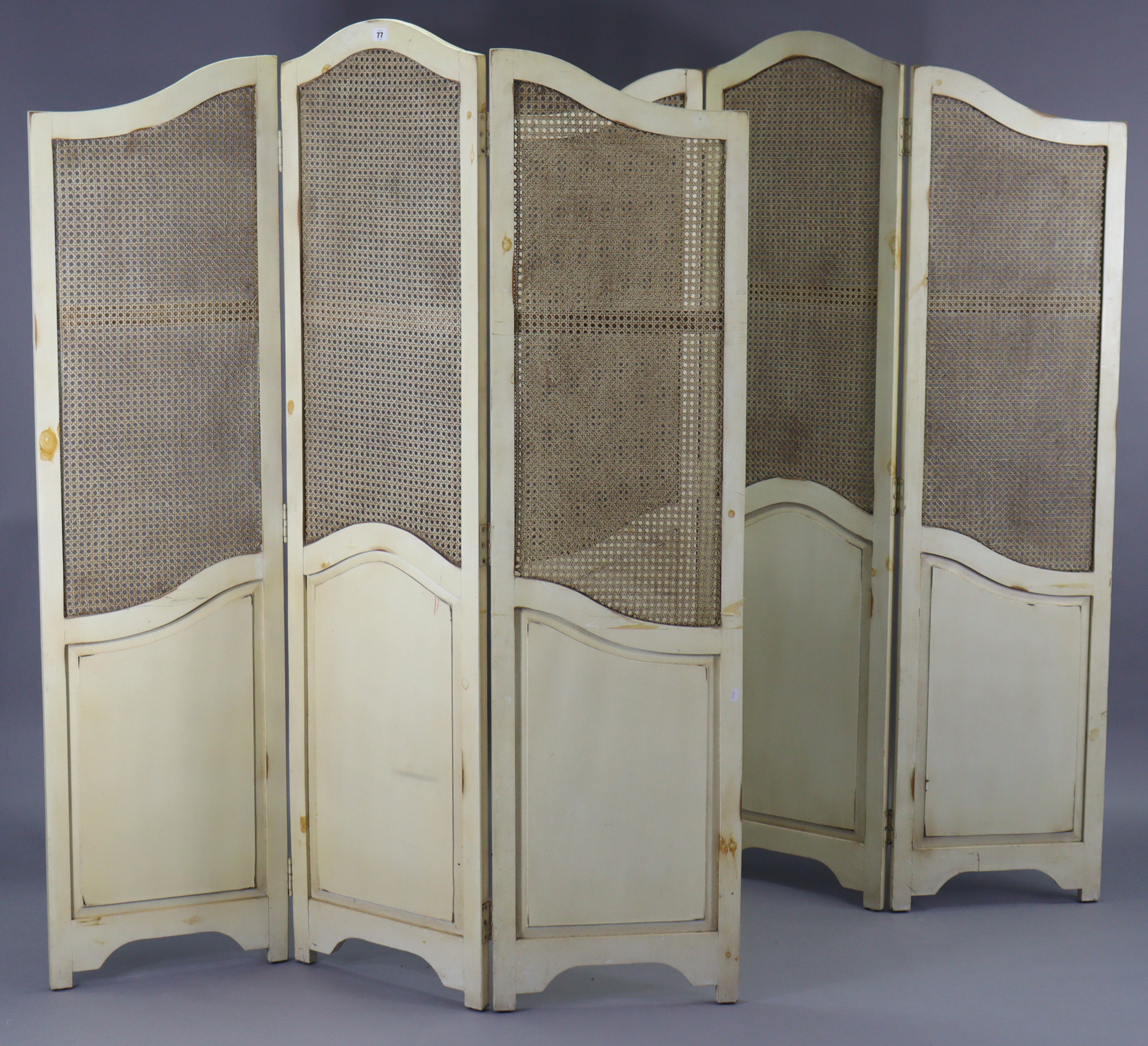 A pair of continental-style white painted wooden three-fold draught screens, each inset with woven-
