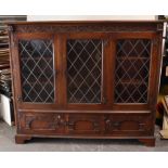 A Jay-cee? oak side cabinet fitted six shelves enclosed by three leaded glazed doors with