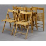 A set of seven teak fold-away chairs with hard seats, & on square legs.