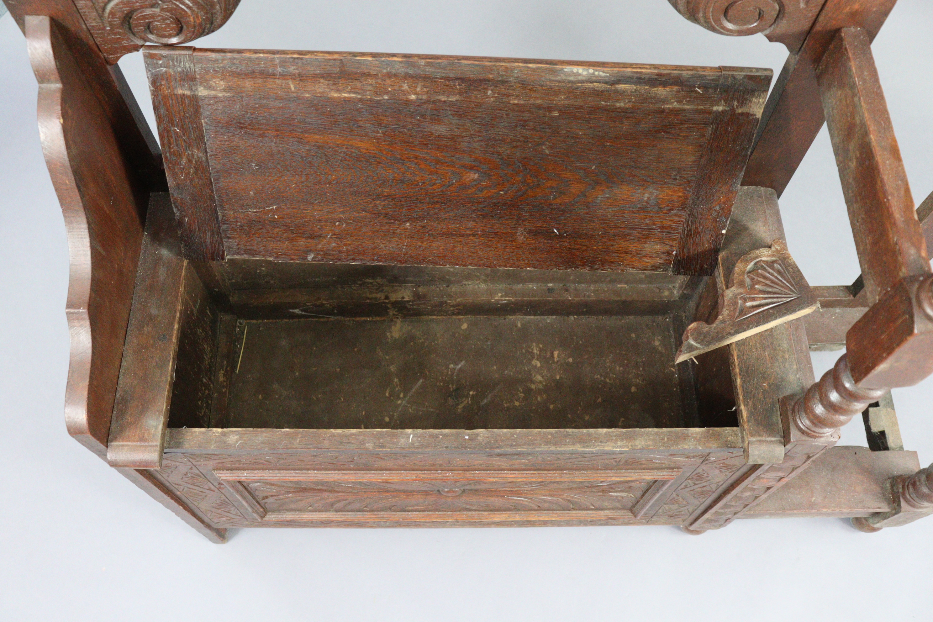 A 1930’s carved oak hall stand inset bevelled rectangular mirror to top, with a hinged box seat & - Image 4 of 7