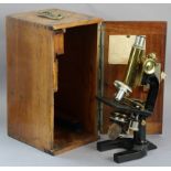 A vintage C. Reichert Wien black lacquered & brass monocular microscope (no. 43342), with a mahogany