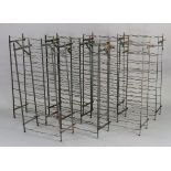 A set of seven vintage wrought metal wine racks, each 20” wide x 40” high x 9” deep.