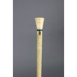 An antique carved whale-bone gent’s walking cane, 32¼” long.