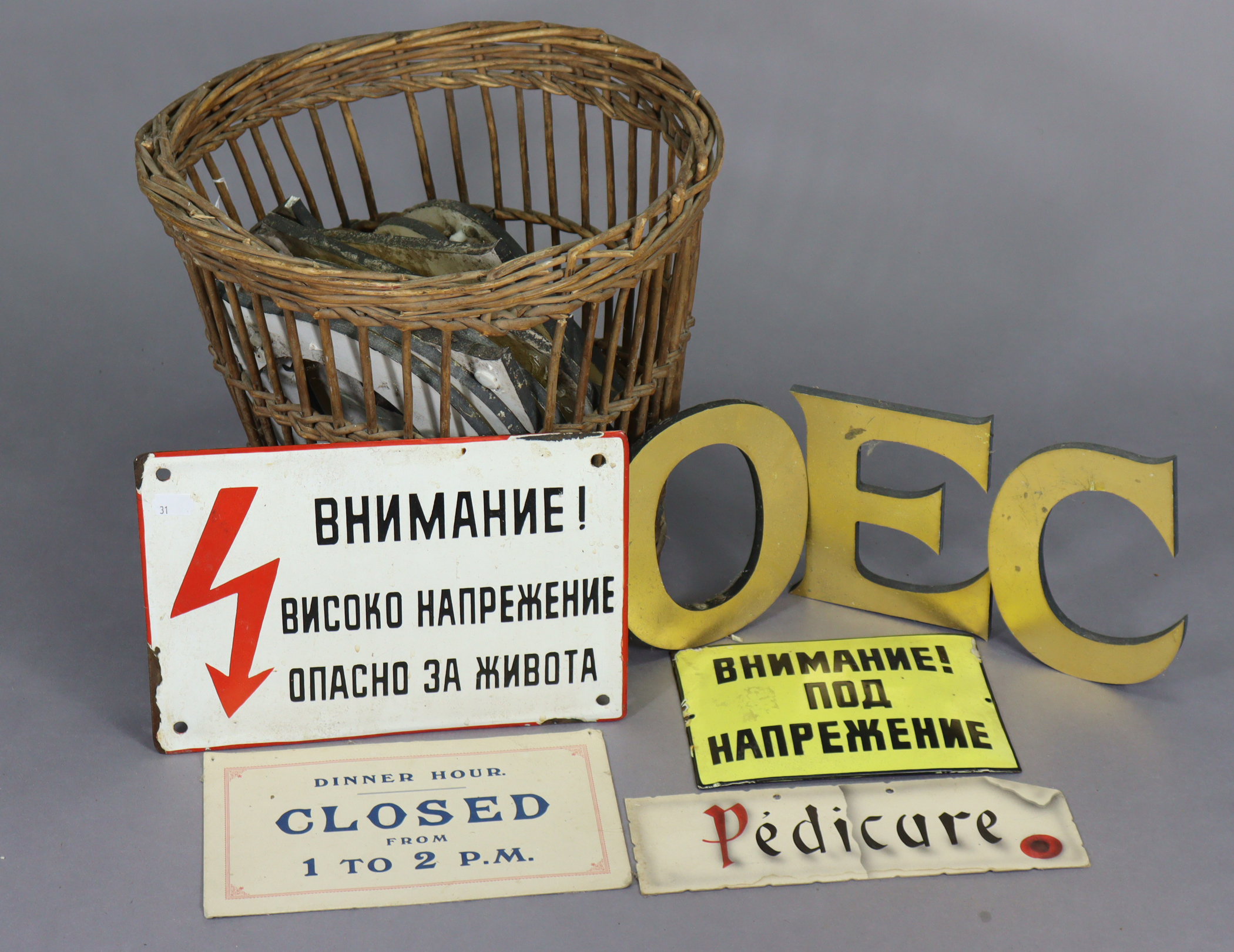 Two Russian enamelled signs; two cardboard signs; a wicker basket; & various gilt-finish letters.