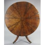 A 19th century figured mahogany pedestal dining table with a circular top, & on a turned centre