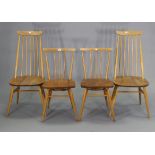 A pair of Ercol spindle-back kitchen chairs with hard seats, & on round tapered legs with spindle