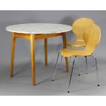 A retro-style circular drop-leaf kitchen table with a white Formica top; & on square tapered legs; &