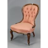 A 19th century buttoned spoon-back nursing chair with a padded seat, & on short cabriole legs with