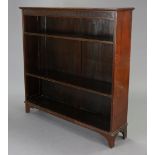 An early 20th century Maple & Co. mahogany standing open bookcase with a fluted frieze, & having two