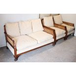 A bergere-style three-piece lounge suite comprising of a two-seater settee inset woven-cane panels