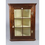 A mahogany hanging corner cabinet fitted two shelves enclosed by a glazed door, 28¾” wide x 38½”