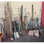 A Black & Decker leaf blower; a wheelbarrow; & various garden tools & hand tools.