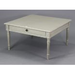 A light grey painted wooden low coffee table with a square top, fitted frieze drawer, & on four