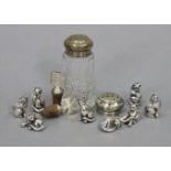A cut-glass sugar sifter with a silver top (hallmarks rubbed); another silver top; two silver-