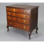 A mid-20th century walnut chest fitted four long graduated drawers with brass knob handles, & on