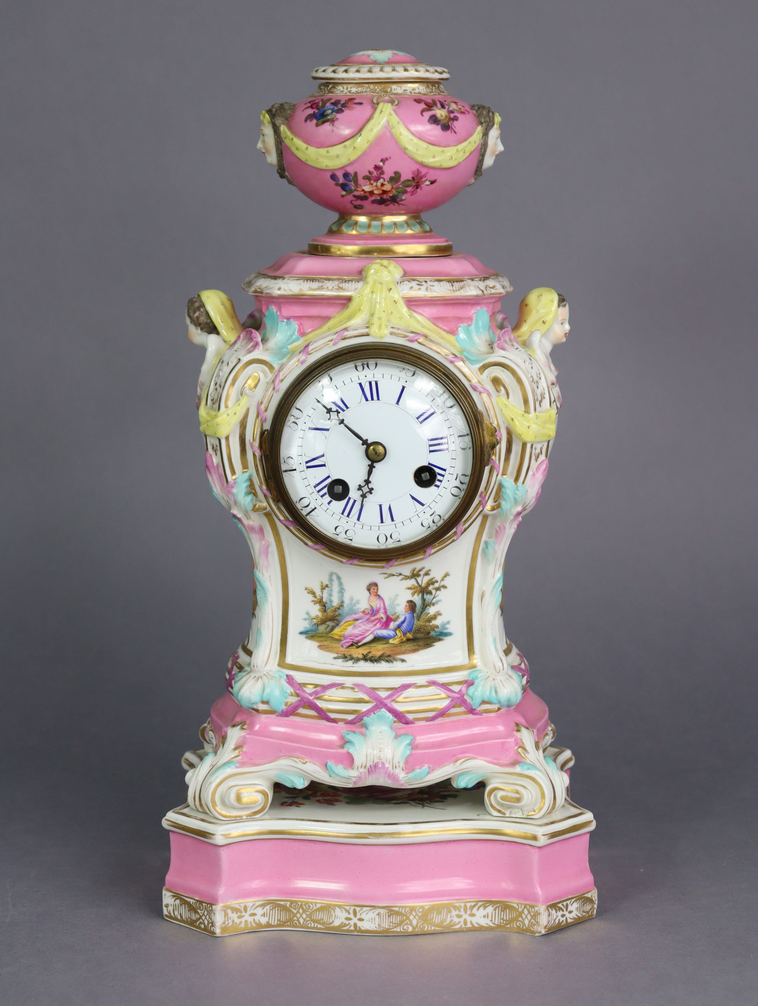 A 19th century Berlin porcelain mantel clock in pink-ground baluster form case, with urn finial &