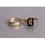 A yellow metal ring set three small graduated diamonds, the shank marked “18K”, size N, 2.3g; &