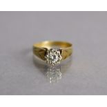 A yellow metal ring set single diamond of approx. 0.2ct, the engraved shank marked “18ct”, size J/K,