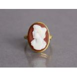 An 18ct gold ring set oval carved agate cameo depicting a classical female bust (slight faults),