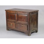 An 18th century oak coffer with moulded edge to the hinged lift top, fitted with two short drawers