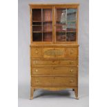 An early 19th century inlaid-mahogany cabinet with moulded cornice above two adjustable shelves