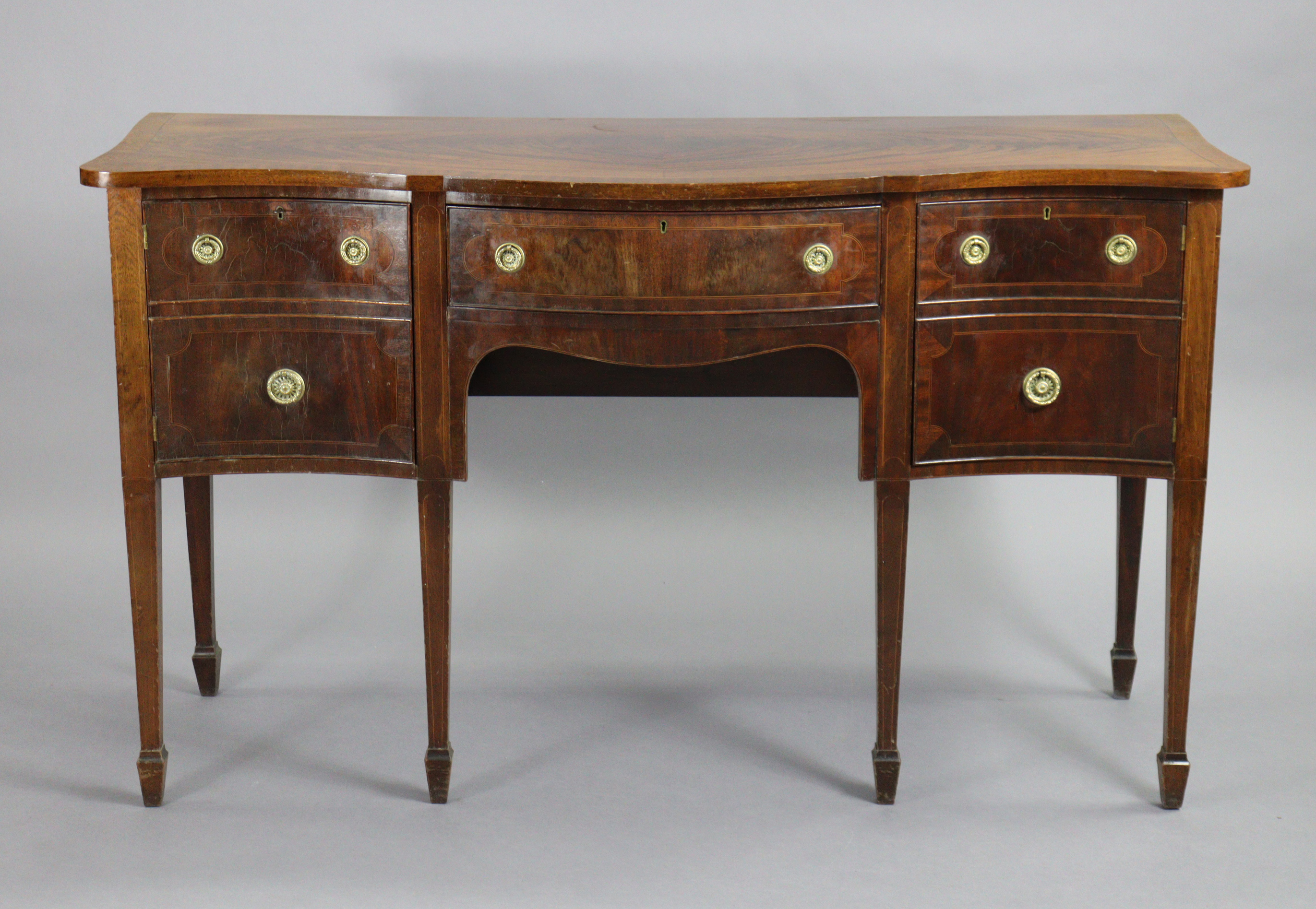 A regency-style serpentine-front mahogany sideboard, with crossbanded rectangular top, fitted single