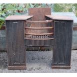 An early 19th century cast-iron fire grate with hob-stand either side above fluted panels, 27½” wide