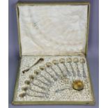 A set of twelve French .950 standard fancy parcel-gilt teaspoons, matching pair of sugar tongs & tea