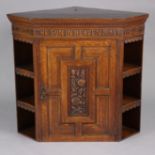 A well-made late 19th/early 20th century oak hanging corner cupboard, the dentil cornice with carved