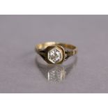A diamond ring, the round-cut stone weighing approx. 0.25 carat, set to a yellow metal shank