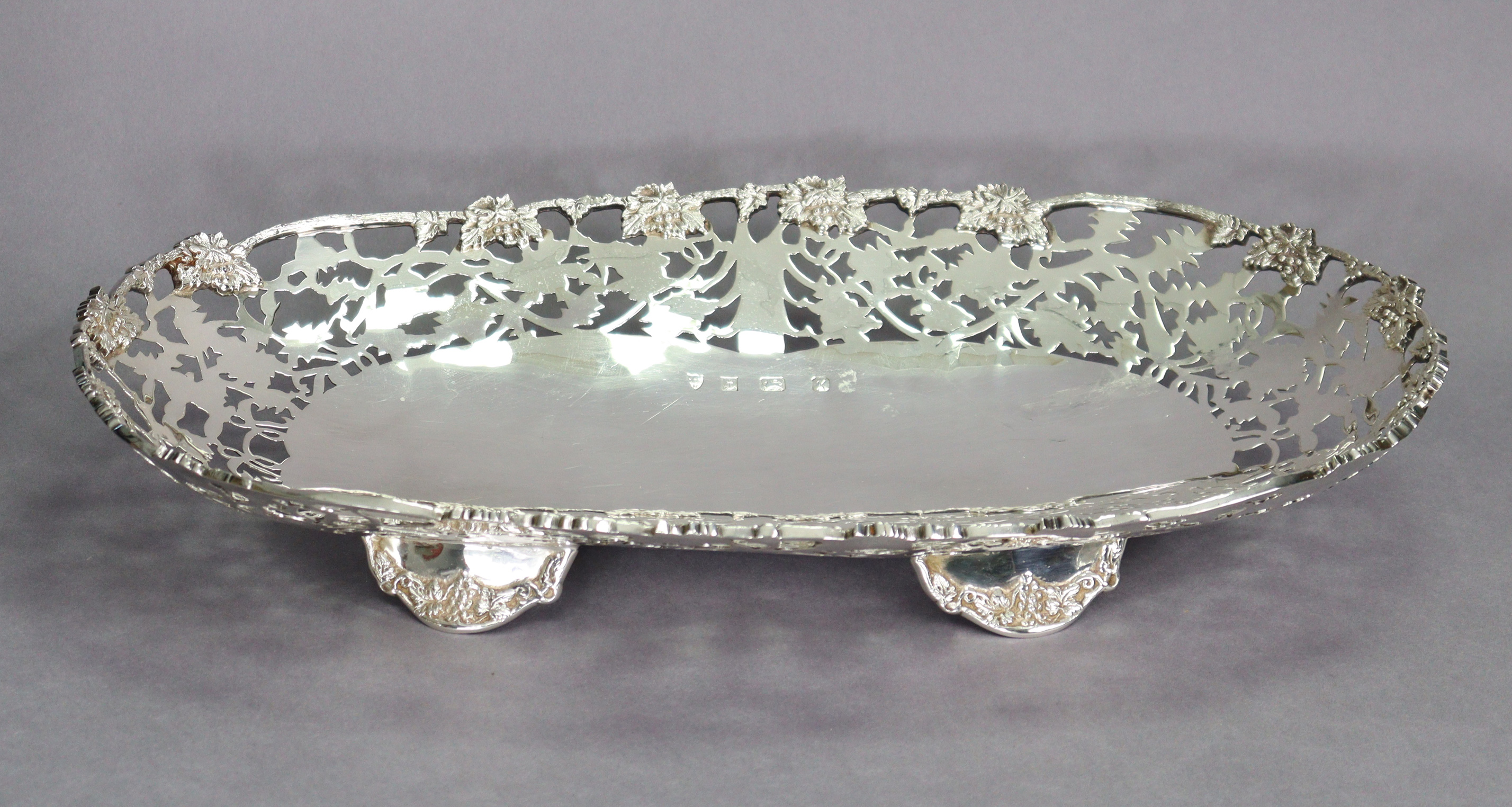 An Elizabeth II silver large oval dish with cast grapevine rim & wide pierced border, on four - Image 4 of 4