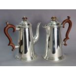 A George IV silver coffee pot of plain round tapered form with domed hinged cover & on moulded foot,