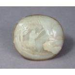 A Chinese white jade roundel, relief-carved with an immortal in a landscape, 2¾” x 3”, set to a