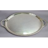 An Elizabeth II silver oval two-handled tea tray with gadrooned rim & leaf-scrolls to the handles,