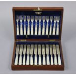 A set of twelve pairs of Edwardian silver dessert knives & forks with engraved decoration & mother-