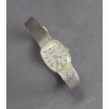 A Bulova stainless steel ladies’ bracelet watch with baton numerals to the silvered cushion-shaped