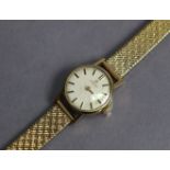 An Omega ladies’ wristwatch in 9ct gold case, the small white circular dial with baton numerals, &