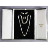 A single row necklace of sixty-seven graduated cultured pearls, the 9ct gold clasp set small