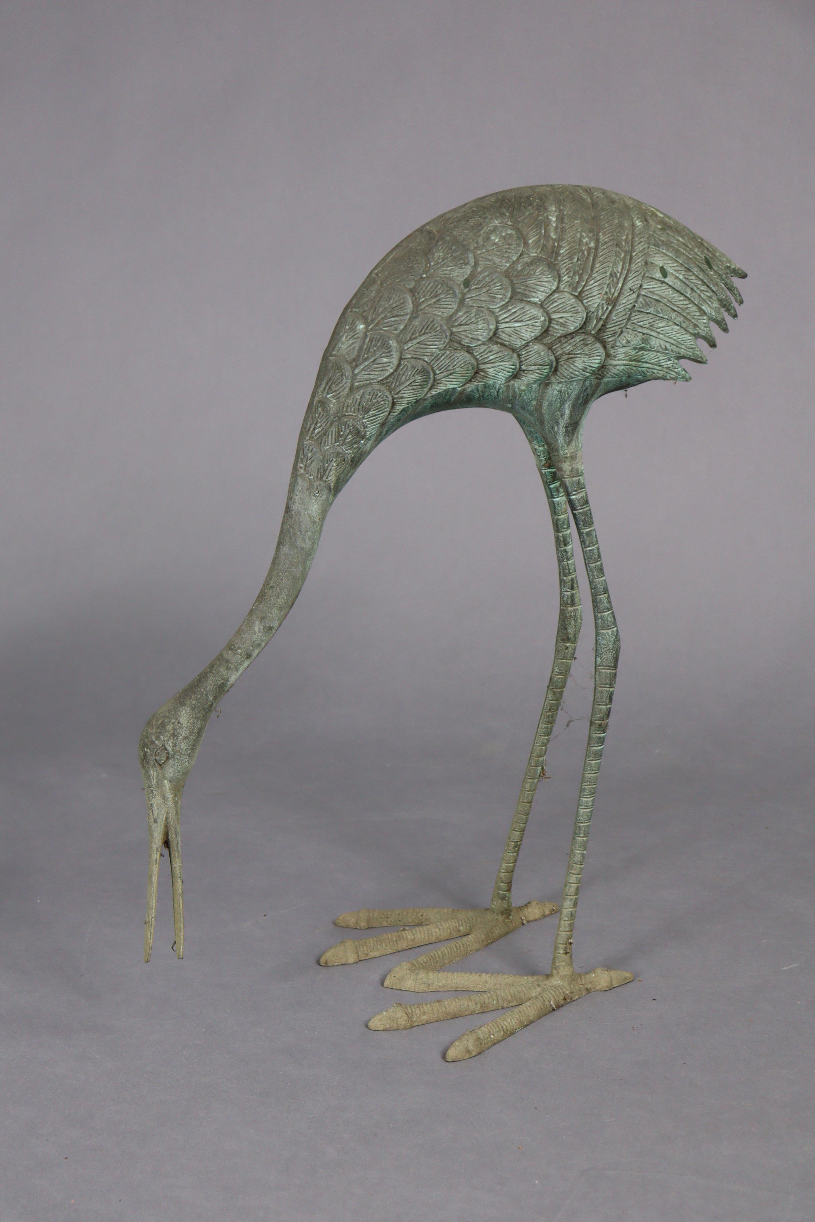 A pair of 20th century metal garden ornaments in the form of standing crane, 35” & 23” high. - Bild 2 aus 3