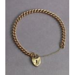 A 9ct gold curb-link bracelet with padlock clasp & safety chain (15.4g).