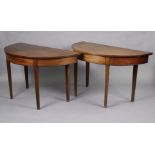 A pair of Georgian mahogany demi-lune side tables, each with plain frieze, on square tapered legs,